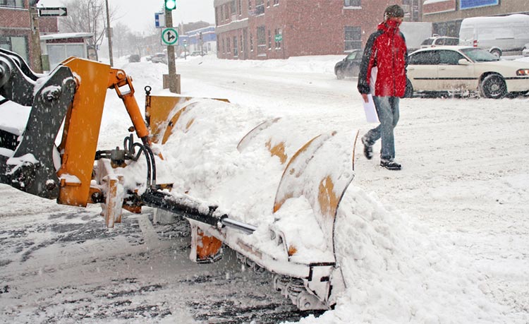 Commercial plow truck clearing a Kitchener parking lot