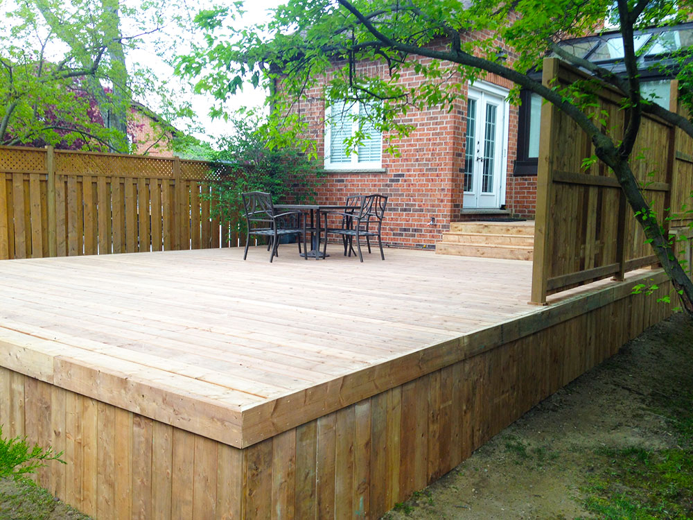 Yard Worx crew finishing a custom back-yard deck and patio