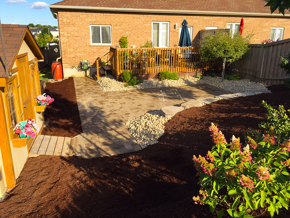 Custom back-yard deck and stone patio built by Yard Worx Landscape