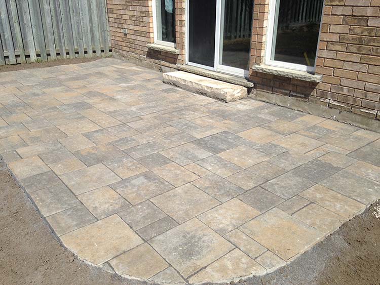Back yard stone patio with seating